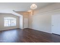 Bright, open-concept living area with vaulted ceilings and durable laminate flooring creates a versatile living space at 10649 W Alvarado Rd, Avondale, AZ 85392