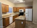 Well-lit kitchen featuring an island, granite countertops, updated appliances, and ample cabinet space at 11016 W Griswold Rd, Peoria, AZ 85345