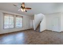 Bright living room with tile floors, staircase, large windows, and ceiling fan at 1244 S Tacoma --, Mesa, AZ 85209
