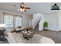 Virtually staged living room with tile floors, neutral furniture, and large windows at 1244 S Tacoma --, Mesa, AZ 85209