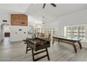 Open concept living room featuring grey flooring, natural light, and game tables for entertainment at 13631 N 70Th Dr, Peoria, AZ 85381