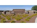 Landscaped community sign with vibrant yellow flowers and brick accents at 1416 E Edwin St, Casa Grande, AZ 85122