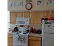 Functional kitchen with white appliances, light wood cabinets, and ample counter space at 14950 W Mountain View Blvd # 5303, Surprise, AZ 85374