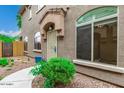 Inviting front entrance with mature landscaping and arched window at 16620 S 48Th St # 79, Phoenix, AZ 85048