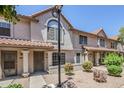Attractive townhome with well-kept landscaping, complemented by a tile roof and light-colored facade at 1961 N Hartford St # 1055, Chandler, AZ 85225