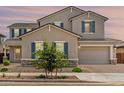 Charming home with neutral stucco, stone accents, and a gray three-car garage at 20451 E Via De Colina --, Queen Creek, AZ 85142
