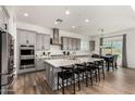 Spacious gray kitchen with stainless steel appliances and a large center island at 20451 E Via De Colina --, Queen Creek, AZ 85142