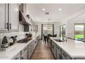Bright kitchen featuring gray cabinets, stainless steel appliances and a long quartz countertop at 20451 E Via De Colina --, Queen Creek, AZ 85142