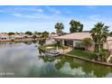 Beautiful waterfront home with well-manicured lawn and private boat dock, perfect for lakefront living at 2128 E Clipper Ln, Gilbert, AZ 85234
