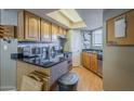 Kitchen features stainless appliances, granite counters, wood cabinets, and ample storage for cooking essentials at 2228 N 52 St # 213, Phoenix, AZ 85008