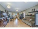 Open-concept living area with light wood floors, neutral walls, and modern lighting fixtures at 2228 N 52 St # 213, Phoenix, AZ 85008