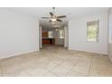 Open-concept living area with tile flooring, neutral paint, arched entryway, and a ceiling fan at 2475 E Vermont Dr, Gilbert, AZ 85295