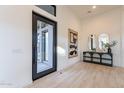 Welcoming entryway with modern decor, light wood floors, and a stylish console table at 25564 N 119Th St, Scottsdale, AZ 85255