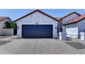 Single-story home features a two-car garage, low-maintenance desert landscaping, and a concrete driveway at 2940 E Norwood St, Mesa, AZ 85213