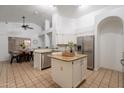 Bright kitchen with white cabinets, stainless steel appliances, and a central island, perfect for entertaining at 3058 E Nance St, Mesa, AZ 85213