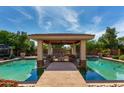 Luxurious pool area with a covered cabana, perfect for outdoor entertaining at 320 N Portland Ave, Gilbert, AZ 85234