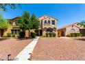 Charming two-story home with a desert landscape and walkway to the front door at 3476 E Orchid Ln, Gilbert, AZ 85296