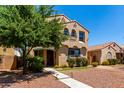 Charming two-story home with a desert landscape and walkway to the front door at 3476 E Orchid Ln, Gilbert, AZ 85296