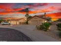 Beautiful home featuring a wide driveway, lush landscaping, and a convenient three-car garage at 3805 E Desert Flower Ln, Phoenix, AZ 85044