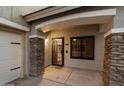 Covered front entryway, stone pillars, front door with black trim, and window at 3932 S Crosscreek Dr, Chandler, AZ 85286
