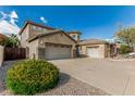 Two-story home featuring a spacious three-car garage, desert landscaping, and tile roof at 4336 W Hackamore Dr, Phoenix, AZ 85083
