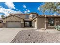 Charming home featuring a spacious three-car garage, stone accents, desert landscaping, and tile roof at 4336 W Hackamore Dr, Phoenix, AZ 85083