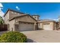 Two-story home featuring a spacious three-car garage, desert landscaping, and tile roof at 4336 W Hackamore Dr, Phoenix, AZ 85083