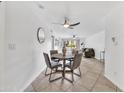 Open-concept dining area featuring a ceiling fan and views into the brightly lit living area with access to the patio at 4354 N 82Nd St # 167, Scottsdale, AZ 85251