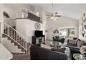Bright living room featuring high ceilings, a staircase, and comfortable seating, perfect for entertaining and relaxation at 441 S Maple -- # 83, Mesa, AZ 85206