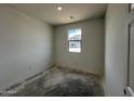 A simple bedroom with a window offering natural light at 47451 W Kenner Dr, Maricopa, AZ 85139