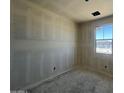 Well-lit bedroom with a window and closet awaiting carpet at 47719 W Kenner Dr, Maricopa, AZ 85139