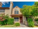 Townhome with beautiful landscaping and a unique window, perfect for a homeowner who values curb appeal at 4901 E Kelton Ln # 1052, Scottsdale, AZ 85254