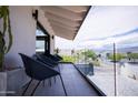 Stylish balcony featuring modern furniture and glass railings with scenic neighborhood views at 5801 E Surrey Dr, Cave Creek, AZ 85331