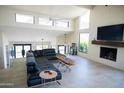 Bright living room with white brick walls, large windows, fireplace, and contemporary furnishings at 5801 E Surrey Dr, Cave Creek, AZ 85331