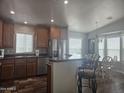 Eat-in kitchen boasts stainless appliances, wood cabinets, and lots of natural light at 650 N Hawes Rd # 3604, Mesa, AZ 85207