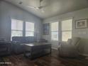 Comfortable living room featuring a ceiling fan and multiple windows with natural light at 650 N Hawes Rd # 3604, Mesa, AZ 85207