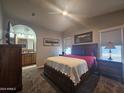 Relaxing main bedroom featuring a ceiling fan, side tables, and ensuite bath at 650 N Hawes Rd # 3604, Mesa, AZ 85207