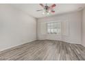 Spacious bedroom with wood floors, ceiling fan and bay window with plantation shutters at 7130 E Laguna Azul Ave, Mesa, AZ 85209
