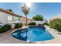 Sparkling pool surrounded by lush greenery, perfect for relaxation and outdoor enjoyment at 7130 E Laguna Azul Ave, Mesa, AZ 85209