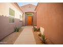 Covered walkway to a stylish front door, complemented by desert landscaping and neutral-toned exterior walls at 7413 E Russet Sky Dr, Scottsdale, AZ 85266