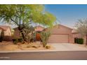 Charming single-story home showcasing desert landscaping, mature trees, and a two-car garage at 7413 E Russet Sky Dr, Scottsdale, AZ 85266