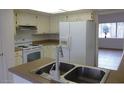 Bright kitchen featuring white cabinets and appliances, and laminate countertops at 8626 E Irish Hunter Trl, Scottsdale, AZ 85258