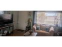 Bright living room features laminate wood flooring and a comfortable sofa at 962 S Main Dr, Apache Junction, AZ 85120