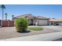 Lovely single-story home with well-maintained desert landscaping and an attached two-car garage at 10557 W Louise Dr, Peoria, AZ 85383