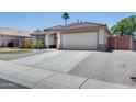 Inviting single-story home with desert landscaping, a tiled roof, and an attached two-car garage at 10557 W Louise Dr, Peoria, AZ 85383