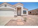 Charming single-story home featuring a stucco exterior, a two-car garage and low maintenance desert landscaping at 11154 W Ashley Chantil Dr, Surprise, AZ 85378