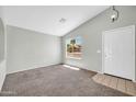 Bright living room with neutral paint, carpet flooring, a large window and a modern ceiling light at 11154 W Ashley Chantil Dr, Surprise, AZ 85378