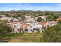 Rear exterior showcasing multiple condos with manicured lawns and mature trees at 11633 N 40Th Way, Phoenix, AZ 85028