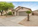 Well maintained home with neutral color palette, two car garage, and drought tolerant landscaping at 11702 W Lincoln St, Avondale, AZ 85323