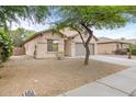 Angle view of home featuring neutral stucco, low maintenance landscaping, and a spacious driveway at 11702 W Lincoln St, Avondale, AZ 85323